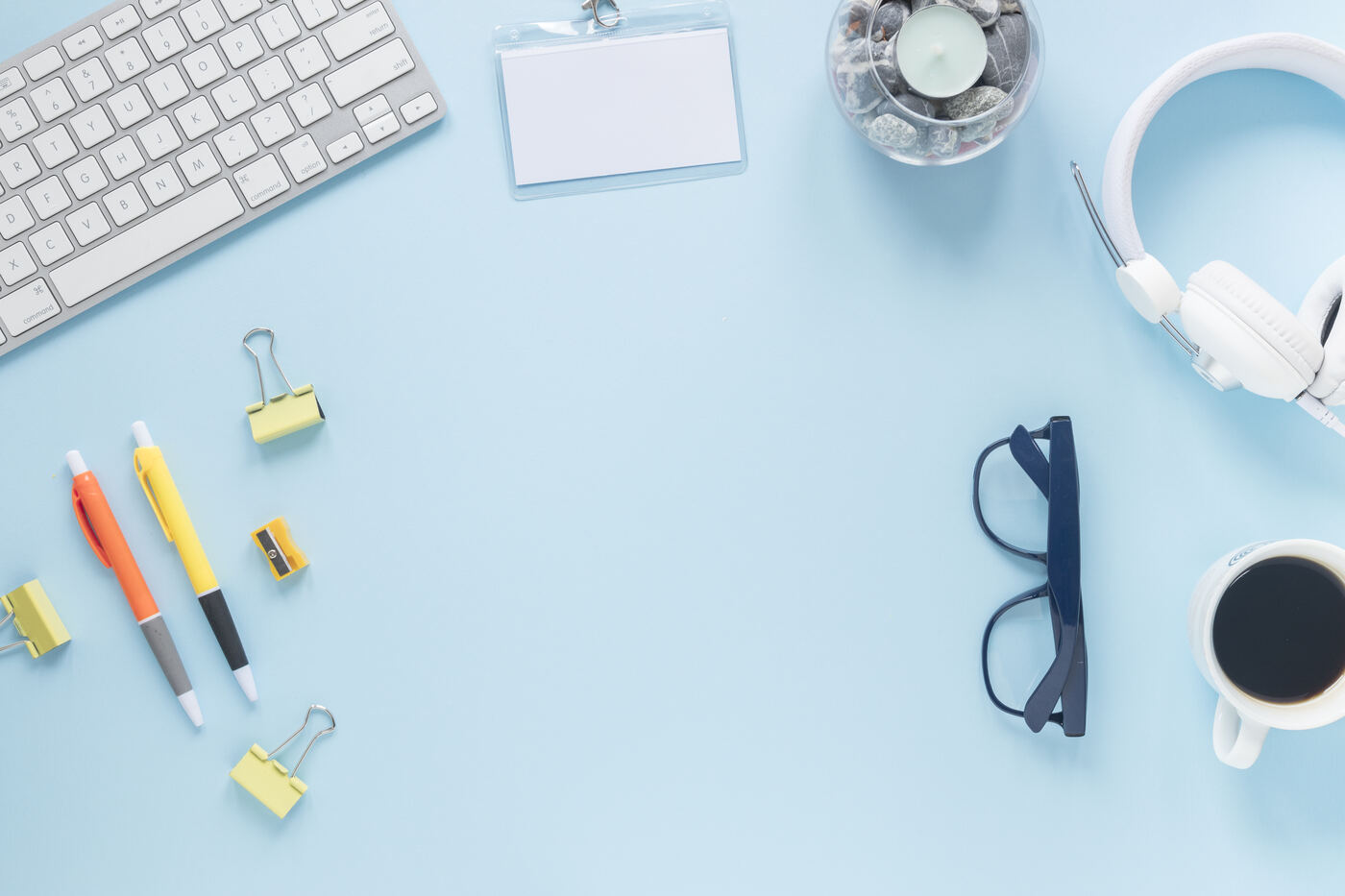 Keyboard, pens and office supplies on a desk